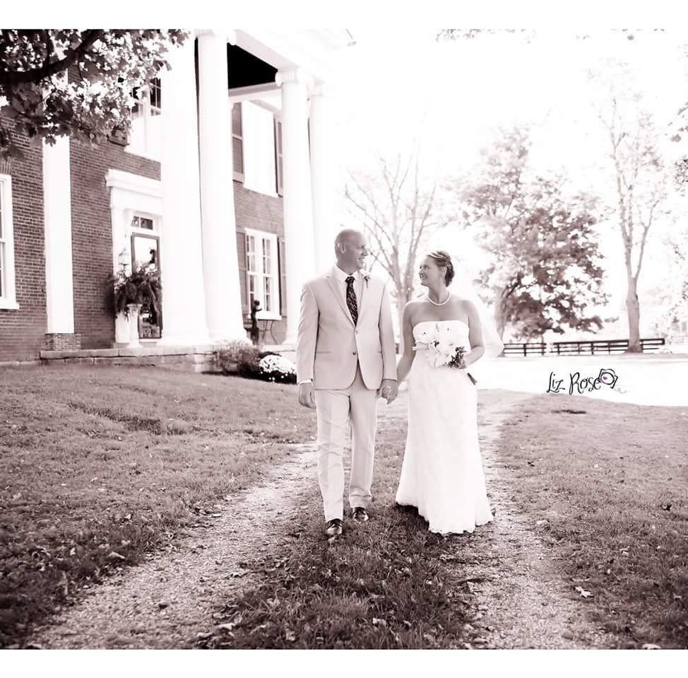 Bride and Groom walking in driveway of Denny House